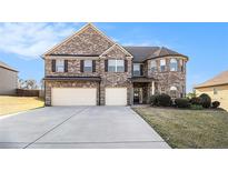 Beautiful two-story brick home with a three-car garage and well-manicured lawn at 3621 Guinevere Trce, Douglasville, GA 30135
