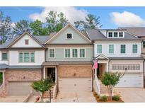 Charming townhome with brick accents, a one-car garage, and well-maintained landscaping at 233 Retreat Ln, Canton, GA 30114