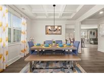 Bright dining room featuring a decorative ceiling, stylish lighting, and a wooden table with bench seating at 372 Garnet Dr, Acworth, GA 30101