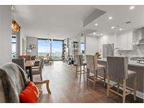 Bright, open-concept living room and kitchen with hardwood floors and large windows offering city views at 270 17Th Nw St # 2804, Atlanta, GA 30363
