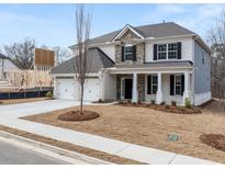 Charming two-story home with a manicured lawn and a two-car garage, perfect for Gathering living at 7166 Linden Dr, South Fulton, GA 30349