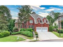 Charming red brick two-story home with well-maintained landscaping and a two-car garage at 389 Mill Creek Ne Bnd, Atlanta, GA 30307
