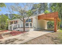 Charming home featuring a carport, a white brick facade, and a well-maintained lawn at 4201 Regal Ridge Rd, Austell, GA 30106