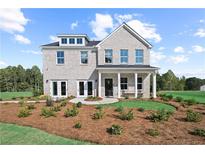 Stunning two-story brick home with covered porch, manicured lawn, and beautiful landscaping at 6106 Marigold Way, Atlanta, GA 30349