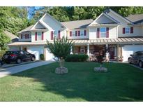 Charming townhome with a well-manicured lawn, attached garage, and lovely curb appeal at 70 Darbys Crossing Ct, Hiram, GA 30141