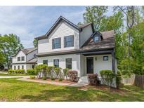 Charming two-story home featuring a white exterior with black trim and a well-manicured lawn at 1410 Eastland Rd Se Rd, Atlanta, GA 30316