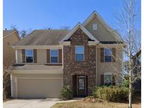 Charming two-story home featuring a brick facade, attached garage, and well-maintained landscaping at 3272 Baylor Cir, Mcdonough, GA 30253