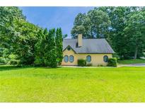 Charming one-story home with a well-maintained lawn and mature trees under a bright sky at 10 Briarcliff Pl, Stockbridge, GA 30281