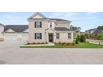 Charming two-story home with brick and stone facade and manicured lawn at 580 Silver Moon Dr, Loganville, GA 30052