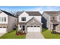 Charming two-story home with stone accents, a two-car garage, and freshly sodded front yard at 2690 Ravencliff Dr, Austell, GA 30168