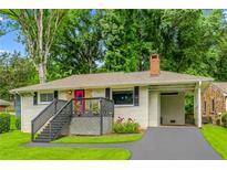 Charming single story home featuring a pink front door, a carport, and mature trees at 240 W Lake Nw Dr, Atlanta, GA 30314
