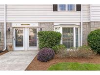Charming front entrance with double doors, stone accents, and a bay window bringing in natural light at 136 Peachtree Memorial Nw Dr # Ct-6, Atlanta, GA 30309