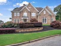 Charming two-story brick home with a landscaped front yard and manicured shrubbery at 5009 Kingsley Manor Ct, Marietta, GA 30066