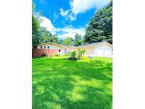 Charming ranch style home featuring an attached garage and well-manicured front lawn at 2807 Mcclave Dr, Doraville, GA 30340