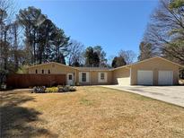 Charming single-story home with a well-maintained front yard and attached two-car garage at 2807 Mcclave Dr, Doraville, GA 30340