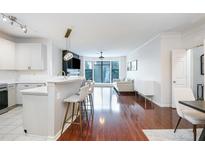 Bright living room features hardwood floors, a breakfast bar, and large windows at 400 17Th Street Nw # 2313, Atlanta, GA 30363