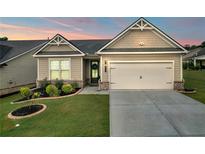 Charming one-story home with manicured lawn and two-car garage at 2292 Knob Creek Rd, Snellville, GA 30078