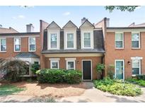 Charming brick townhome with manicured landscaping and a welcoming entrance at 4167 Oakwood Way, Duluth, GA 30096