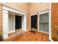 Charming townhome entrances featuring brick flooring and stylish black doors with white trim at 7500 Roswell Rd # 18, Sandy Springs, GA 30350