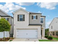 Charming two-story home with a white brick and gray siding exterior at 1399 Flathead River Ln, Marietta, GA 30064