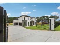 Stunning two-story home features a gated entrance, three-car garage and lush landscaping at 3061 Bold Springs Rd, Dacula, GA 30019