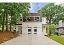 Modern home featuring a two-car garage, a mix of wood and white siding and a manicured front yard at 1238 Memorial Se Dr # A, Atlanta, GA 30316