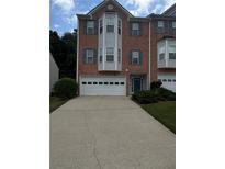 Charming brick townhome with a two-car garage and beautiful landscaping at 1346 Pilgrim Lake Dr, Cumming, GA 30040