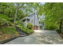 Charming home featuring a two-car garage and staircase leading to the front entrance at 610 Lake Dr, Snellville, GA 30039