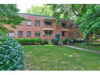 Charming brick building with landscaped front yard and a variety of plants and greenery at 1400 Chalmette Ne Dr # 2, Atlanta, GA 30306
