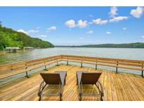 Waterfront property features a private dock with plenty of space for relaxing by the lake at 627 Apache Trl, Woodstock, GA 30189