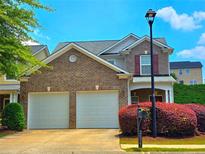 Charming two-story home with a brick facade and two-car garage, complemented by a well-manicured front yard at 2077 Appaloosa Way Way, Conyers, GA 30012
