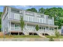 Modern townhome featuring a gray exterior, multiple decks, and manicured landscaping at 458 Connally Se St, Atlanta, GA 30312