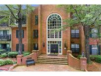 Elegant brick building featuring a grand entrance with a large window and well-maintained landscaping at 26303 Plantation Ne Dr # 303, Atlanta, GA 30324