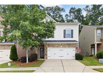 Charming two-story home with brick accents, an attached garage, and a well-manicured front lawn at 403 Village Vw, Woodstock, GA 30188