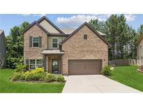 Charming two-story brick home with well-manicured lawn and attached two-car garage at 4967 Zoya Sw Ct, Atlanta, GA 30331