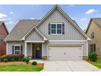 Charming home featuring neutral siding, a two-car garage, and a well-maintained front yard at 3018 Patriot Square, Marietta, GA 30064