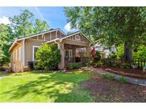 Charming single-story home with a well-maintained lawn and inviting front porch at 210 Evans Dr, Decatur, GA 30030