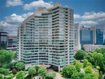 Stunning high-rise condo with curved architecture, floor-to-ceiling windows, and lush green surroundings at 700 Park Regency Ne Pl # 805, Atlanta, GA 30326