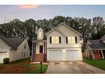Charming two-story home with a two-car garage and inviting front porch with decorative columns at 2169 Wingfoot Pl, Decatur, GA 30035