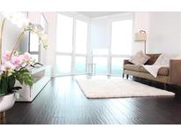 Bright living room with hardwood floors, large windows and a comfortable sofa at 2870 Pharr Court South Nw # 2507, Atlanta, GA 30305