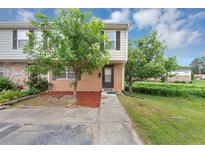 Charming townhome with a brick and vinyl exterior, a well-maintained lawn, and mature trees at 4701 Flat Shoals Road Rd # 37H, Union City, GA 30291