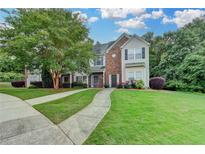 Charming two-story home with well-maintained lawn, mature trees, and a welcoming walkway at 2803 Snapfinger Manor Mnr, Decatur, GA 30035