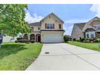 Two-story home with red shutters, manicured lawn, and a long driveway at 7196 Toccoa Circle, Union City, GA 30291