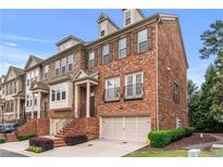 Beautiful brick townhome with attached garage, charming facade, and manicured landscaping at 2428 Hadlow Ln # 25, Atlanta, GA 30339