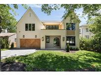 Stunning two-story home featuring a beautiful brick facade, wooden garage doors, and well-maintained landscaping at 2609 Dogwood Terrace Ne, Atlanta, GA 30319