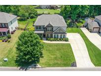 Two-story home featuring a well-manicured lawn and a spacious driveway, beautiful landscaping at 3420 Pleasant Springs Dr, Cumming, GA 30028