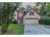 Charming two-story home with a brick accent and a well-maintained front yard at 1464 Claredon Dr, Lawrenceville, GA 30043