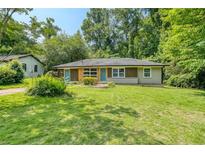 Charming single story home with a well-manicured lawn and mature trees providing shade at 2935 Catalina Dr, Decatur, GA 30032