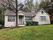 Charming single-story home with a well-maintained lawn, mature trees, and a cozy front porch at 901 Cumberland Rd, Atlanta, GA 30306