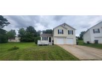Inviting home featuring a well-maintained lawn, charming porch, and convenient two-car garage at 341 Brookside Dr, Mcdonough, GA 30253